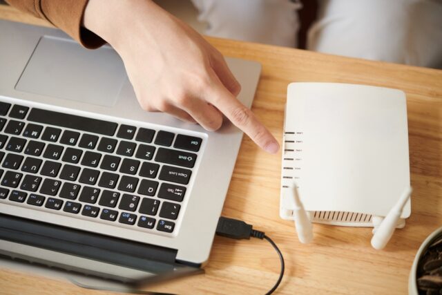 Closeup,Image,Of,Man,Setting,Up,Wi-fi,Router,To,Get